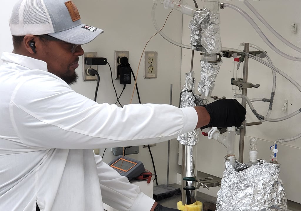 ActiveSite technician operating laboratory reactor equipment for catalyst testing and process development.